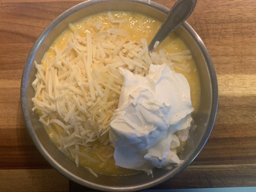 egg cheese sour cream mixture in bowl with fork