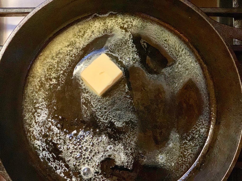 melt butter in cast-iron skillet