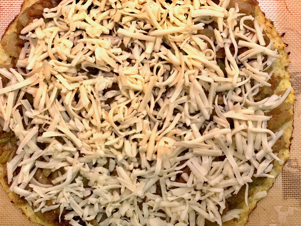 spread braised fennel on paleo cauliflower pizza crust 