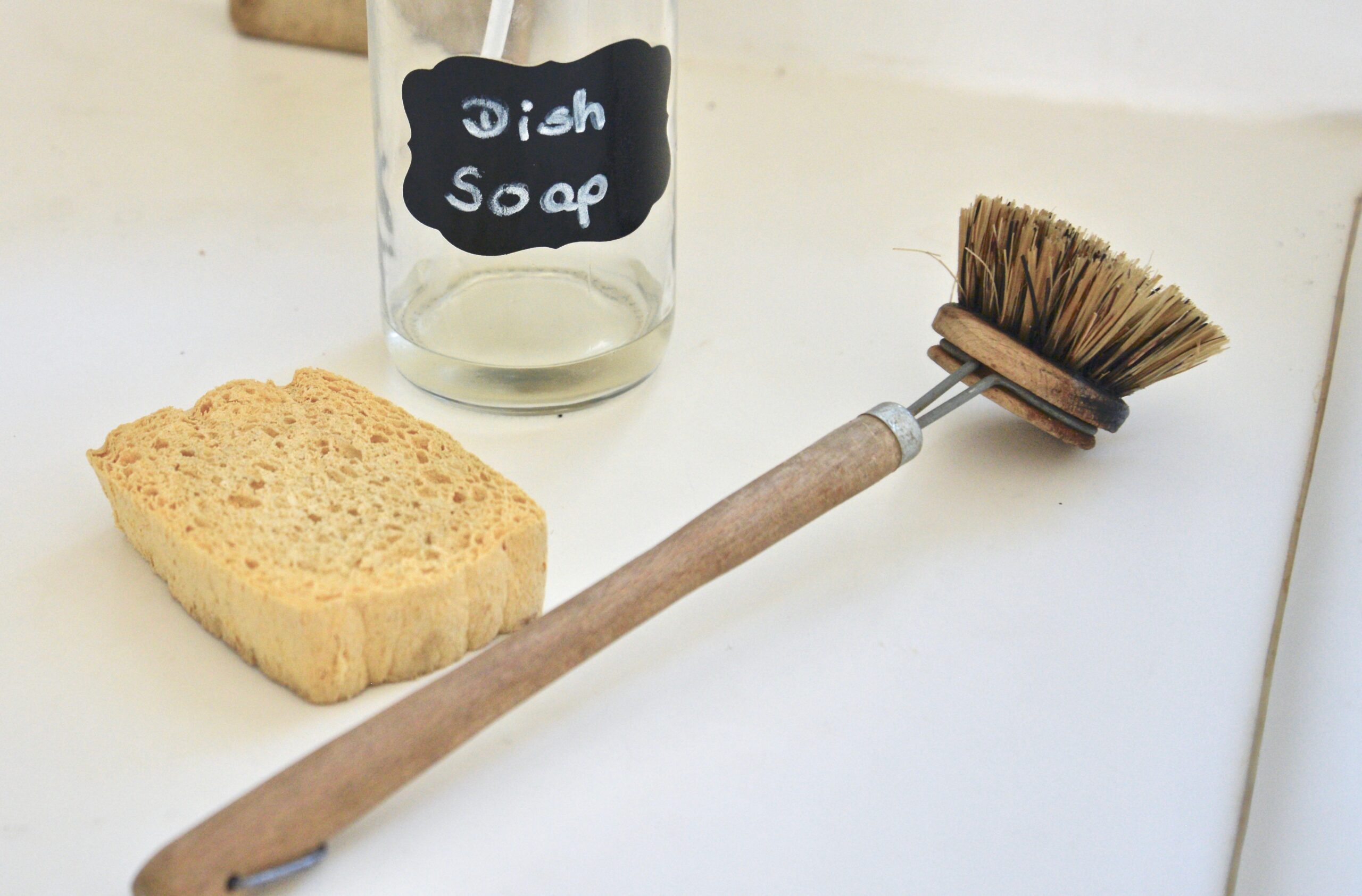 wooden dish brush, cellulose sponge, and homemade dish soap