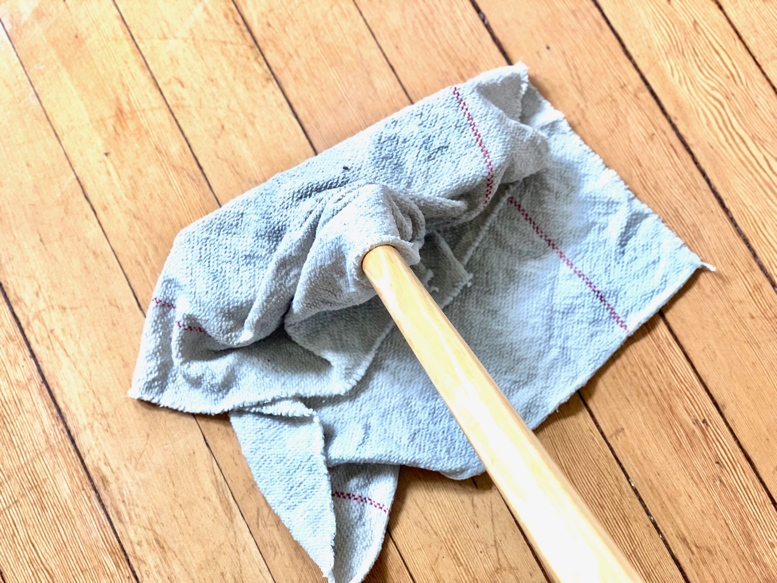 mop rag draped over wooden scrubber brush