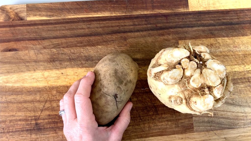russet potato and celery root on cutting board