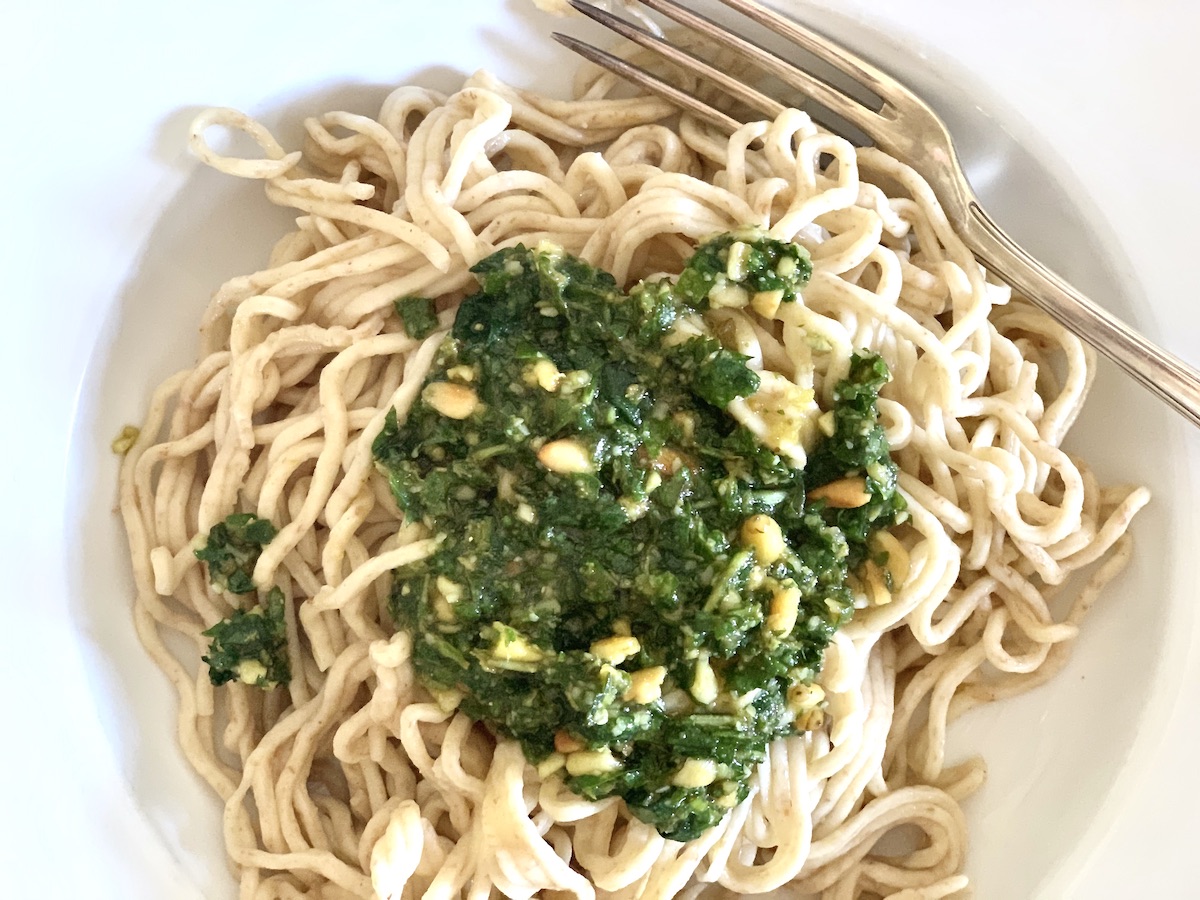 sourdough spaghetti with green pesto on a plate