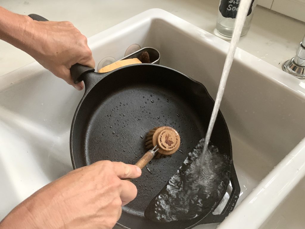 cleaning cast iron with wooden brush