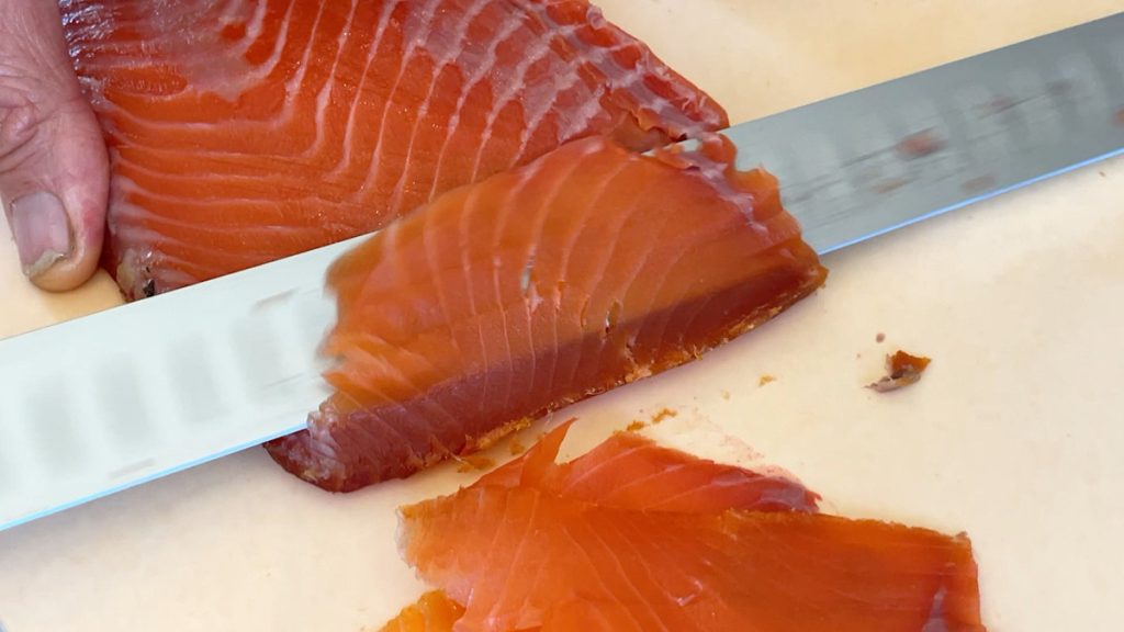 slicing cold smoked salmon