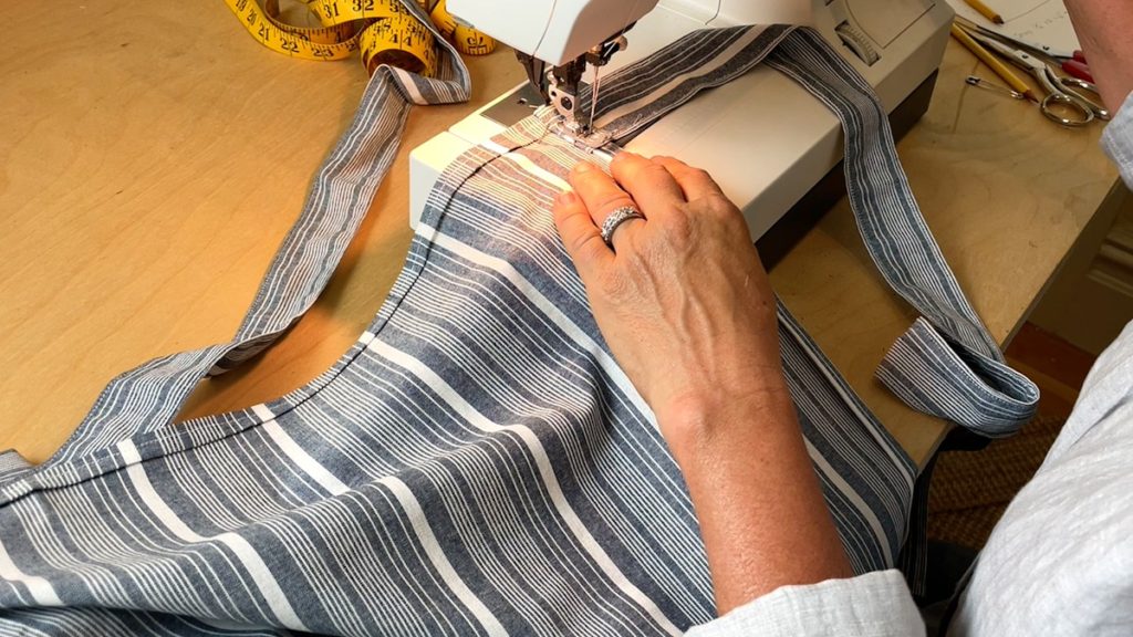 sewing the straps to the half apron